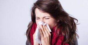 A woman sneezes