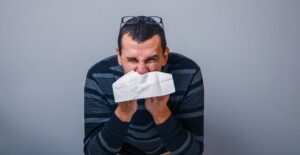 A man blows his nose