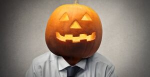 Man wears a pumpkin on his head of Halloween