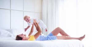 A woman plays with her child