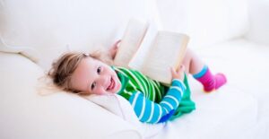 A young girl reads while on holiday break from school