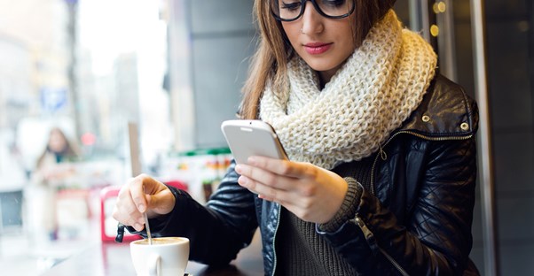 Girl looks at GRE apps on her phone
