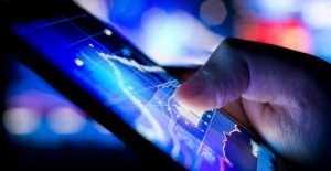 Person holding a tablet computer and looking up investment information