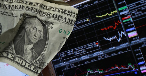 Dollar bill sitting on a digital chart