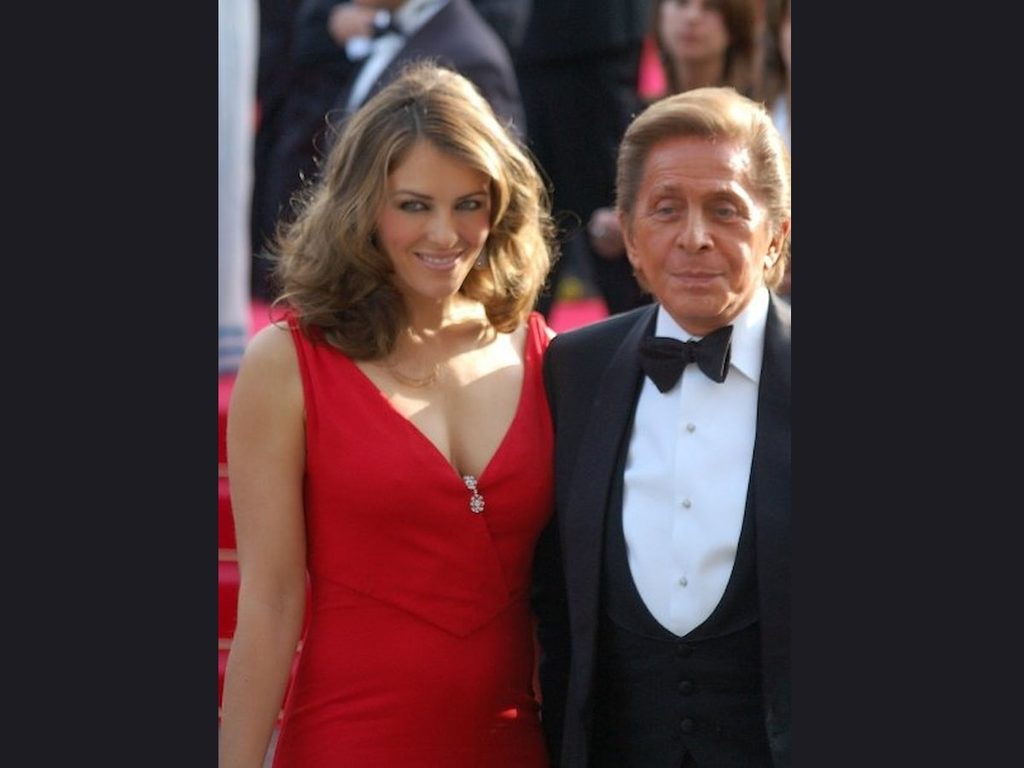 Designer Valentino and actress Elizabeth Hurley wearing one of his gowns.