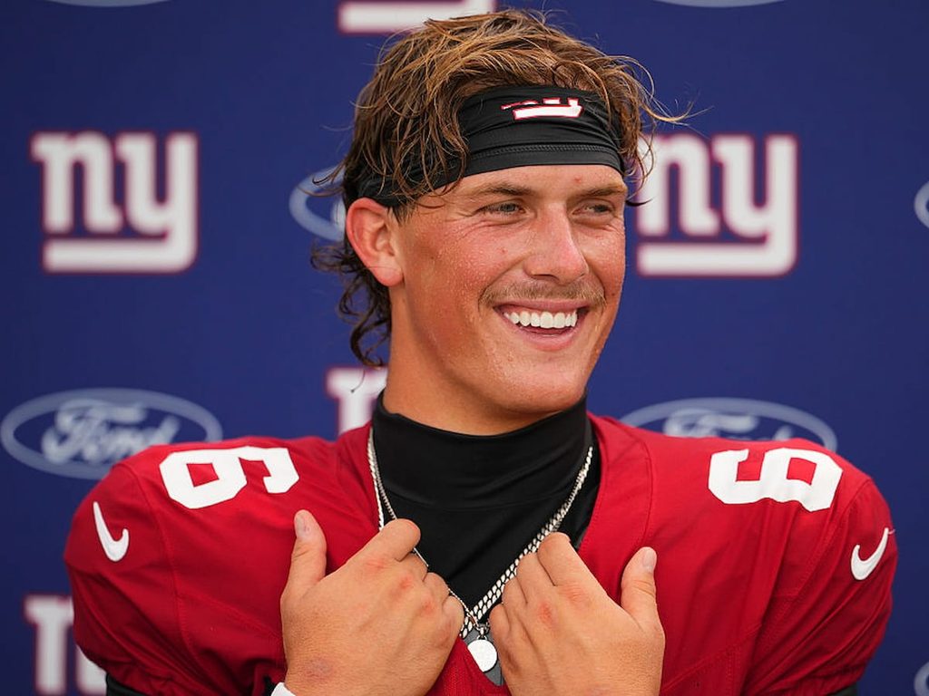 Jaxson Dart smiles while answering questions at a press event following a NY Giants practice.