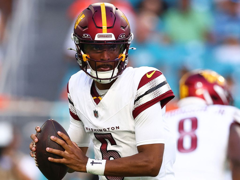 Jayden Daniels practices a play during a warm-up before a Commanders game.