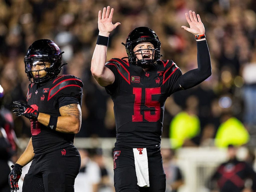 Will Hammond of Texas Tech gestures toward the sideline during the middle of a game.
