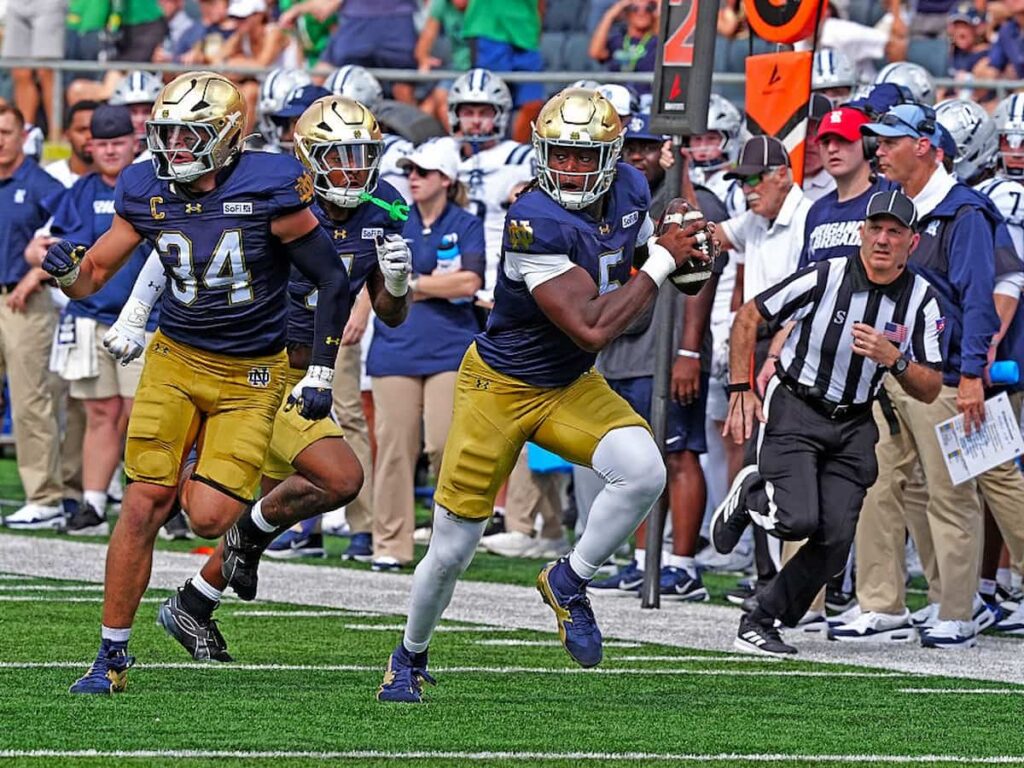 Defensive Lineman Boubacar Traore of the Notre Dame Fighting Irish rushes down the sideline with the ball during a football game.