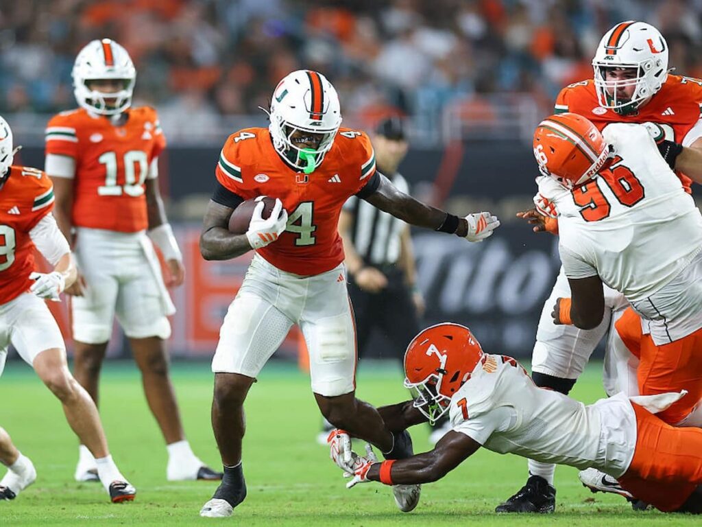 Mark Fletcher, Jr. of the Miami Hurricanes tries to avoid a tackle during a game.