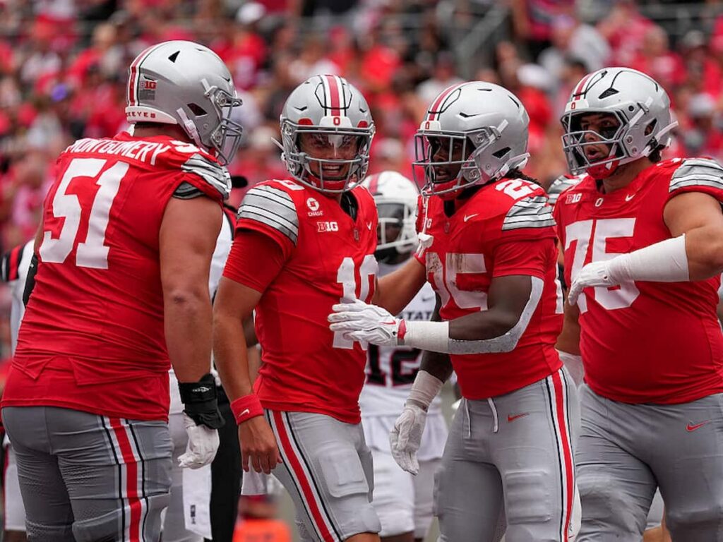 Ohio State Buckeyes offensive lineman Luke Montgomery celebrates a successful defensive play with his teammates.