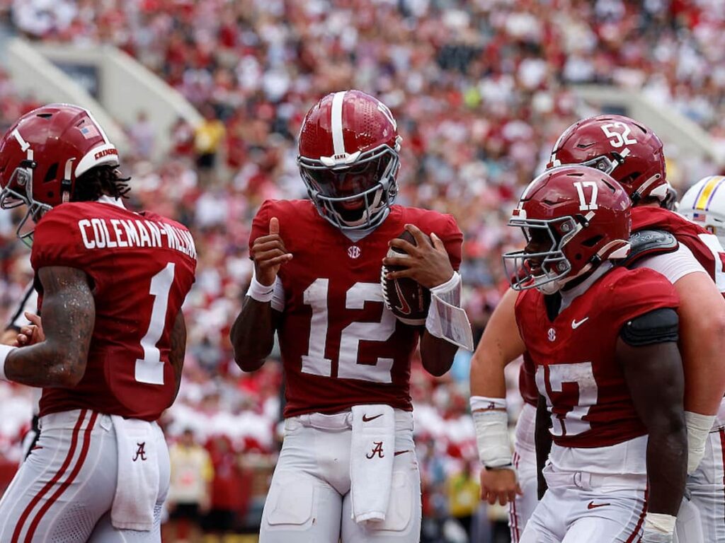 Alabama quarterback Keelon Russell celebrates a touchdown with his teammates.