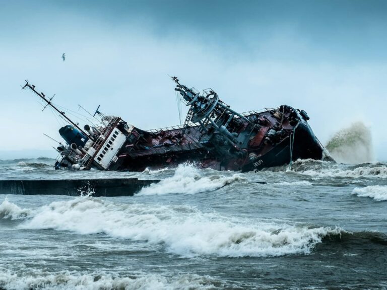 A ship wrecks and overturns in dangerous rough water during a Pacific hurricane.