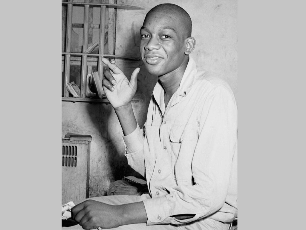 A 1946 photograph of Willie Francis crossing his fingers in a St. Martinsville, Louisiana, prison cell.